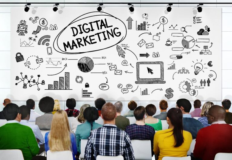 An audience at a seminar facing a screen of digital marketing sketches