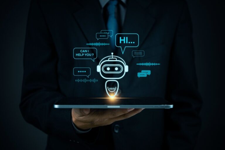 A businessman holding a tablet with a glowing chatbot icon and speech bubbles above it