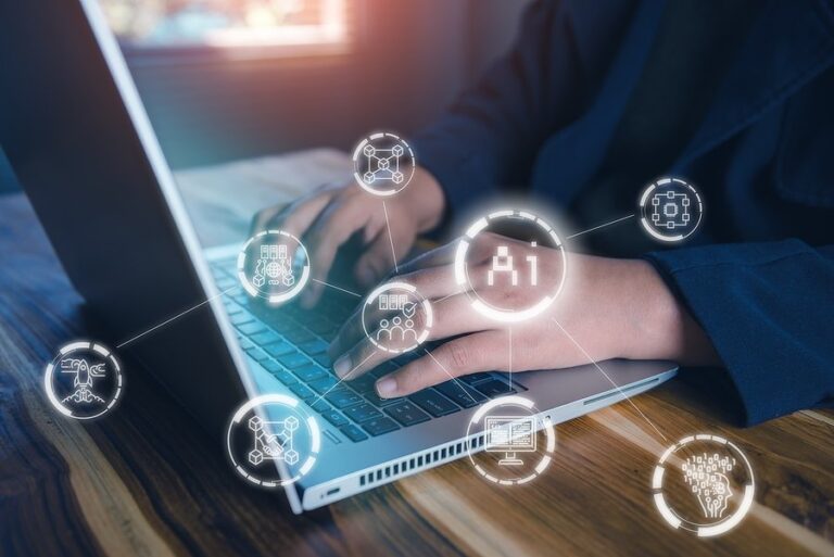 Hands typing on a laptop with glowing AI and technology icons over the keyboard