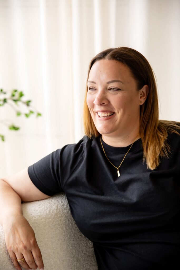 Clair Bryant, founder of The Handy Marketing Company, smiling and looking out of a window